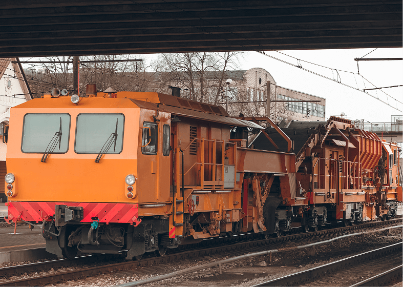 Orange maintenance train on railway tracks