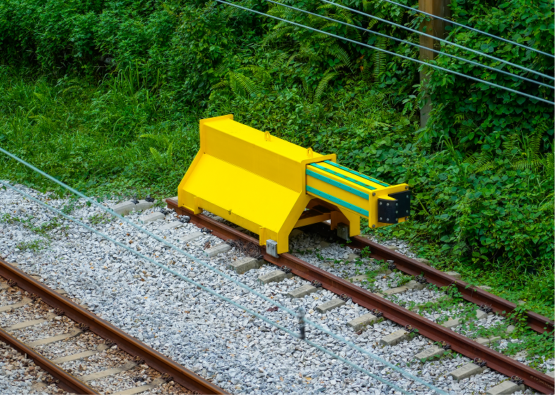 Yellow rail bumper on train tracks