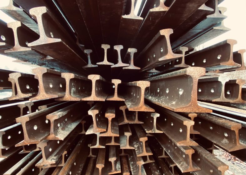 Stack of various steel I-beams arranged vertically.